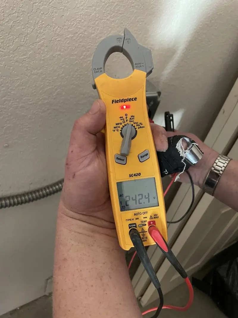 Voltage testing with clamp meter during Outlet Installation in Harbor Bluffs